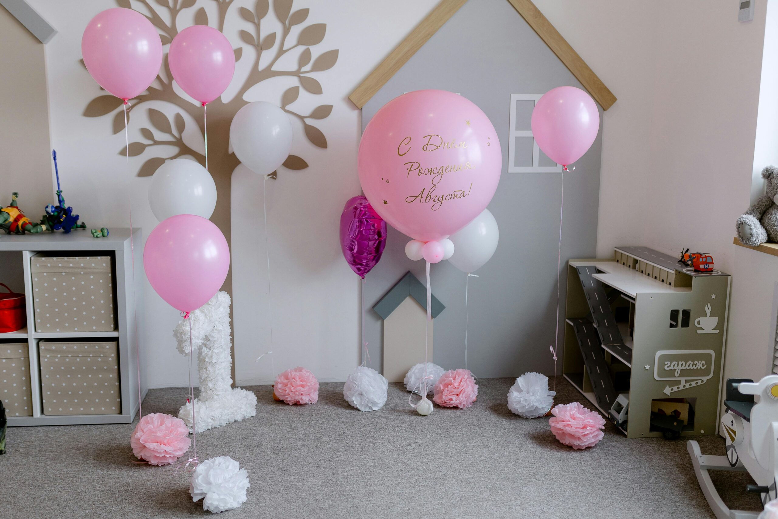 A delightful children's birthday setup with pink balloons and playful decorations in a cozy room.